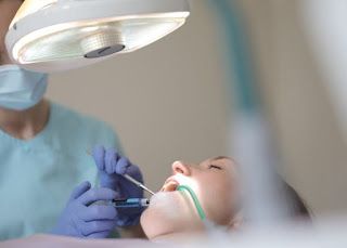 Dentist discussing sleep dentistry and sedation options with an anxious patient